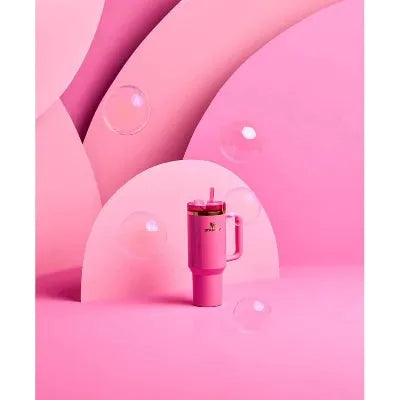 Pink 40oz tumbler with straw on bubble-themed backdrop